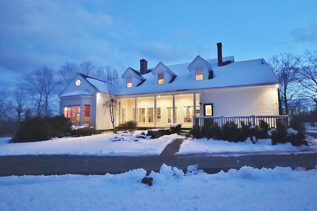 snow covered property featuring a porch