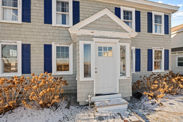 view of snow covered property entrance