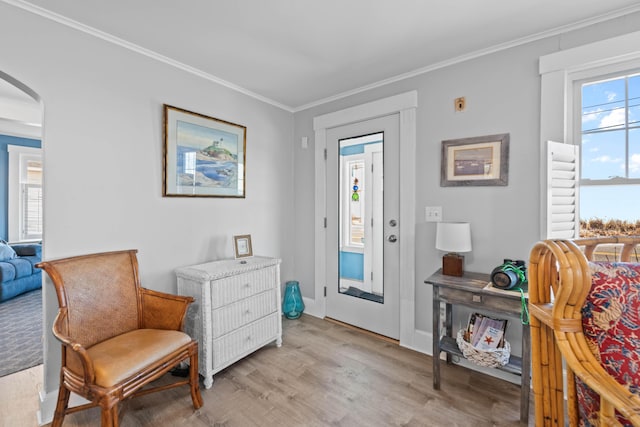 sitting room featuring light wood-type flooring and crown molding