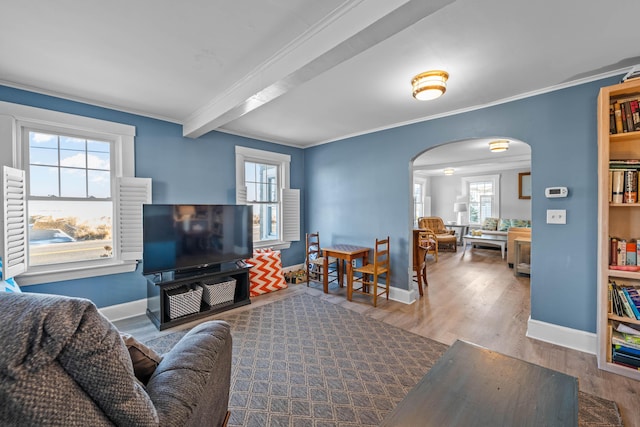 living room with beam ceiling, hardwood / wood-style flooring, and crown molding