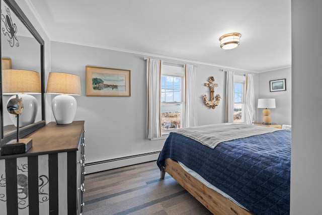 bedroom with carpet flooring, crown molding, and a baseboard heating unit