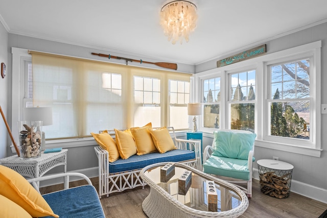 sunroom / solarium with plenty of natural light and a chandelier