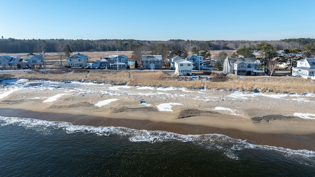 drone / aerial view featuring a view of the beach and a water view