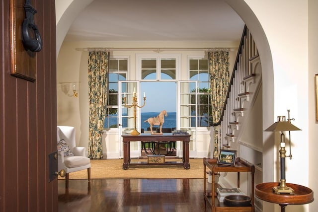 sitting room featuring hardwood / wood-style floors and a water view