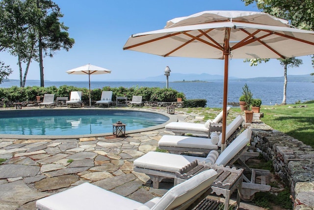 view of swimming pool with a water view