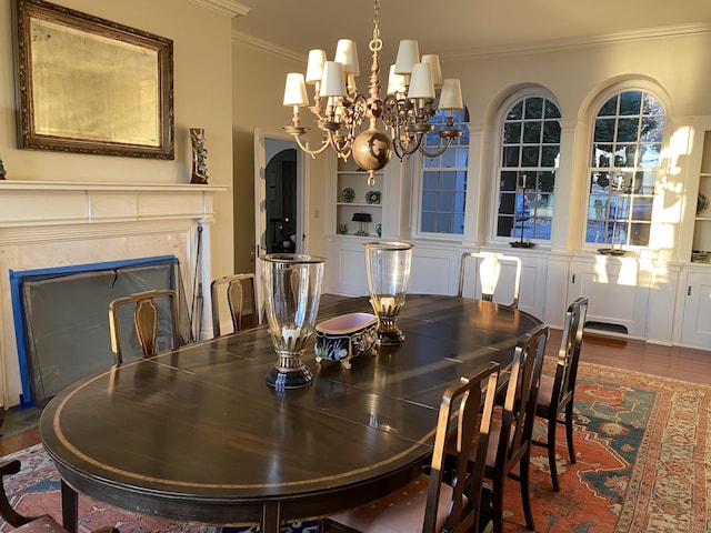 399 Hermits Point Rd, Islesboro, ME 04848 - dining room featuring ornamental molding, wood finished floors, a chandelier, built in shelves, and a premium fireplace