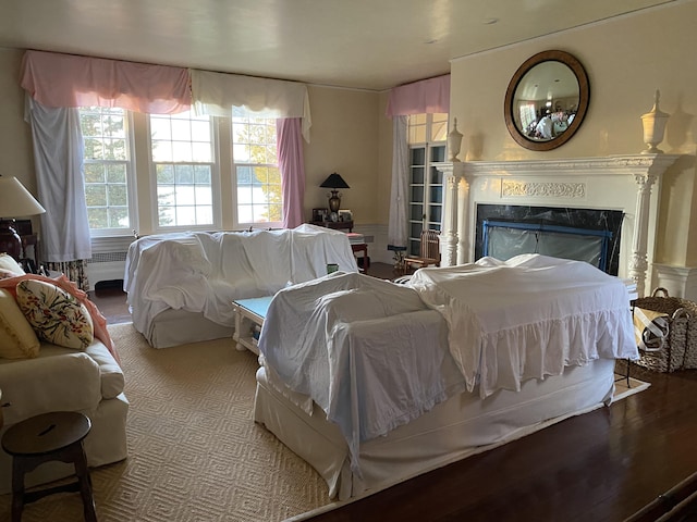 399 Hermits Point Rd, Islesboro, ME 04848 - bedroom with wood finished floors, a high end fireplace, and radiator heating unit