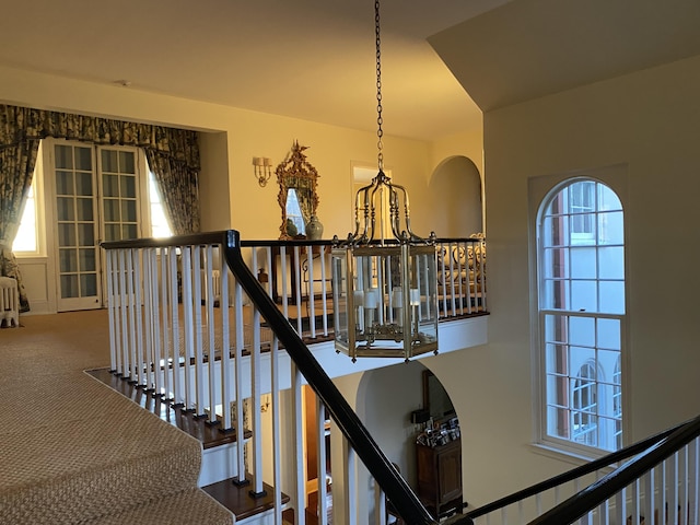 399 Hermits Point Rd, Islesboro, ME 04848 - staircase with a notable chandelier and carpet