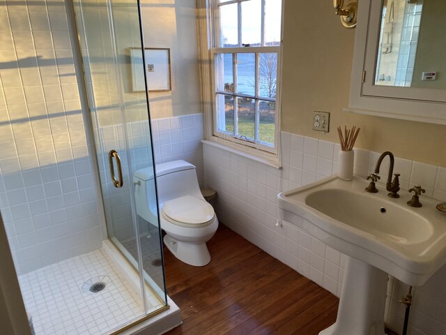 399 Hermits Point Rd, Islesboro, ME 04848 - full bath featuring tile walls, a shower stall, toilet, and wood finished floors