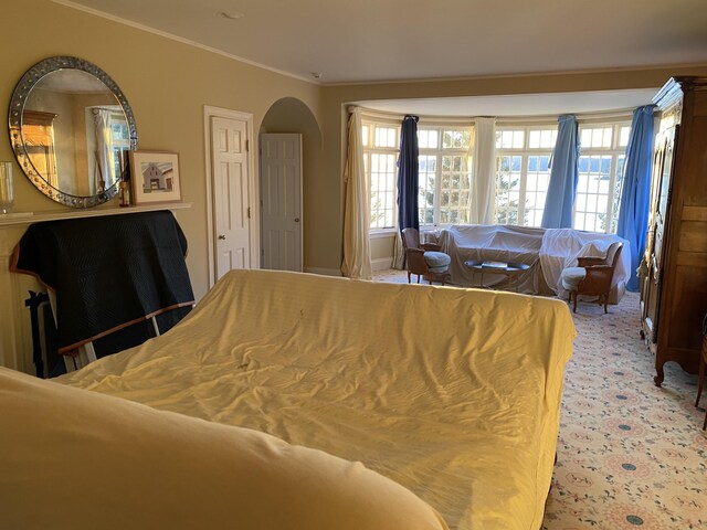 399 Hermits Point Rd, Islesboro, ME 04848 - carpeted bedroom featuring ornamental molding and arched walkways