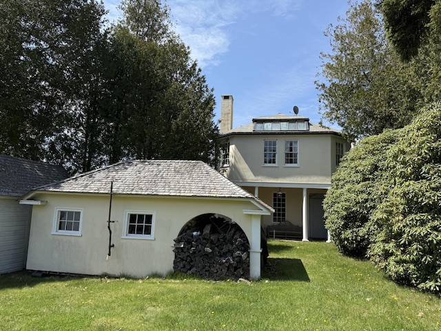 399 Hermits Point Rd, Islesboro, ME 04848 - back of property featuring a lawn, stucco siding, and a chimney