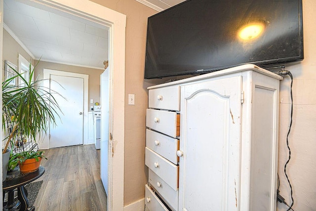 interior space with hardwood / wood-style floors and crown molding