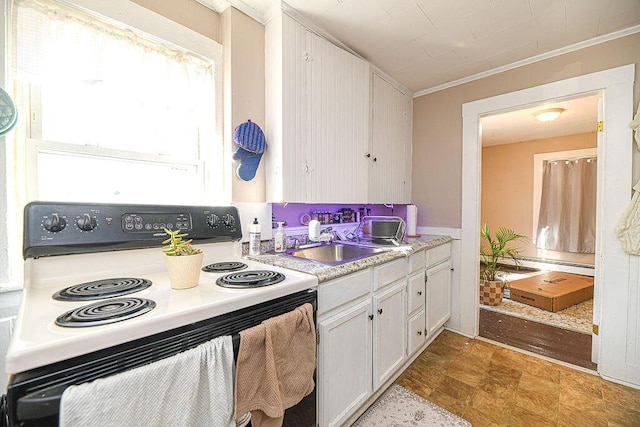 kitchen with white range with electric cooktop, white cabinets, baseboard heating, and crown molding