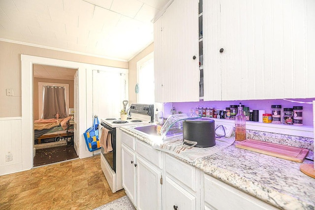 kitchen featuring white cabinetry, white electric range, and crown molding