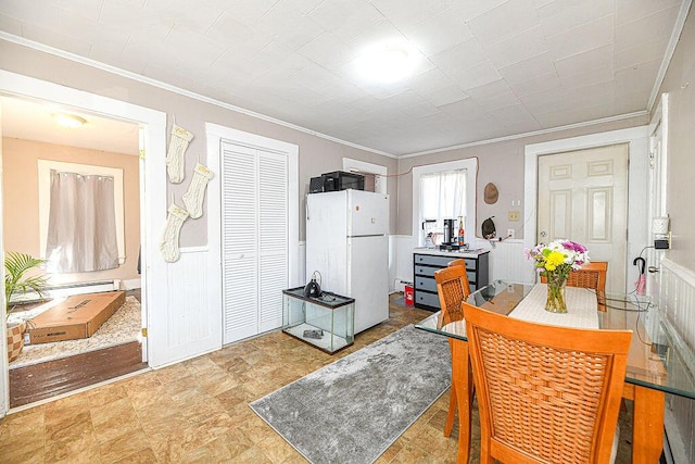 kitchen with crown molding, a baseboard radiator, and white refrigerator