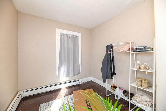 interior space with dark hardwood / wood-style floors and a baseboard heating unit