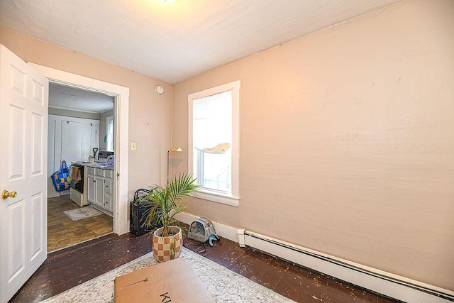 workout room featuring a baseboard radiator and dark hardwood / wood-style floors