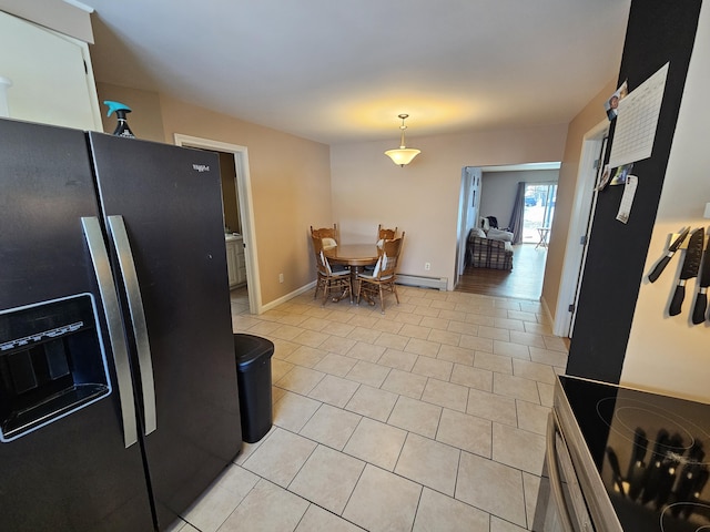 kitchen with stove, hanging light fixtures, a baseboard radiator, light tile patterned flooring, and black fridge with ice dispenser