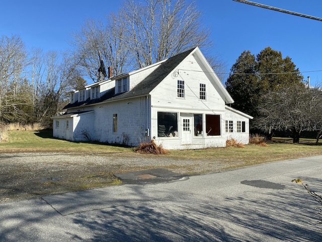 view of side of property with a lawn