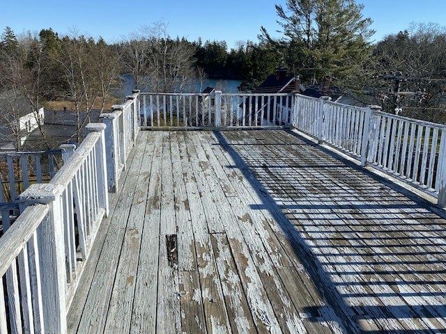 wooden terrace featuring a water view