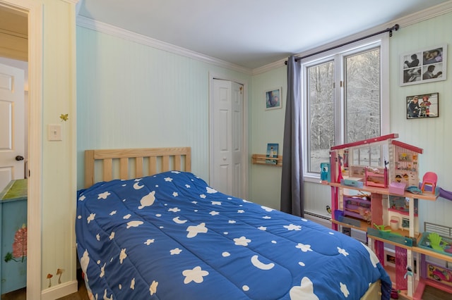 bedroom with ornamental molding, baseboard heating, and a closet