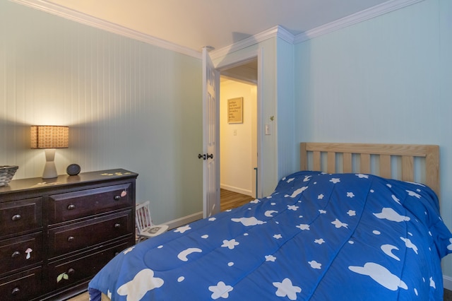 bedroom featuring hardwood / wood-style flooring and ornamental molding