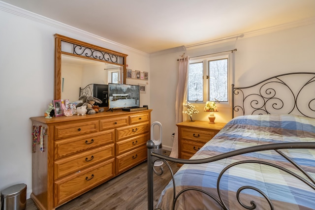 bedroom with dark hardwood / wood-style flooring and ornamental molding