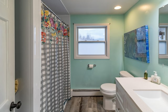 bathroom featuring vanity, hardwood / wood-style flooring, toilet, baseboard heating, and curtained shower