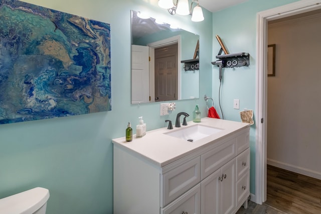 bathroom featuring vanity, hardwood / wood-style flooring, and toilet