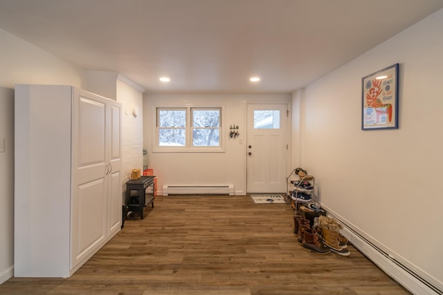 doorway with baseboard heating and dark wood-type flooring