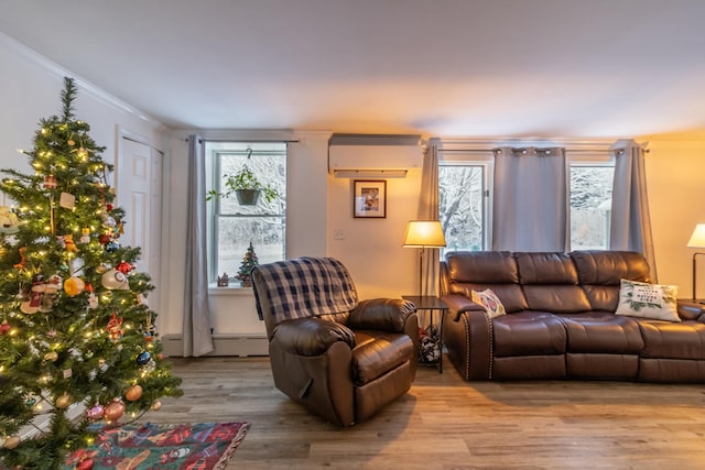 living room featuring an AC wall unit, crown molding, light hardwood / wood-style floors, and a baseboard heating unit