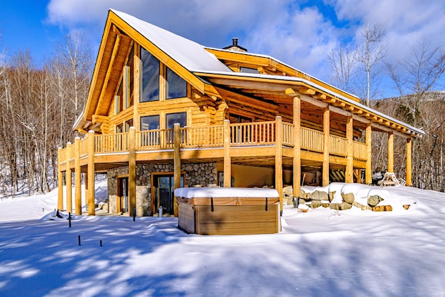 exterior space with a hot tub and a wooden deck