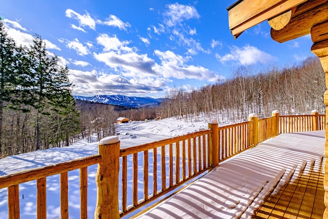 snow covered deck featuring a mountain view