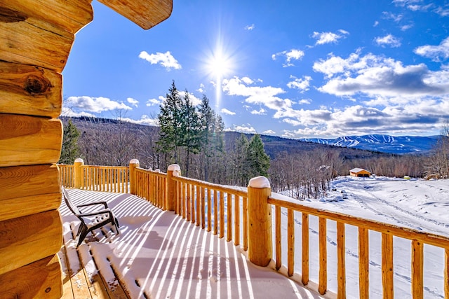 snow covered deck featuring a mountain view