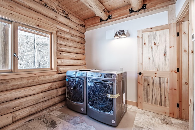 laundry area with washing machine and dryer, wood ceiling, and log walls