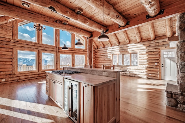 kitchen featuring a center island, wooden ceiling, hanging light fixtures, wine cooler, and light wood-type flooring