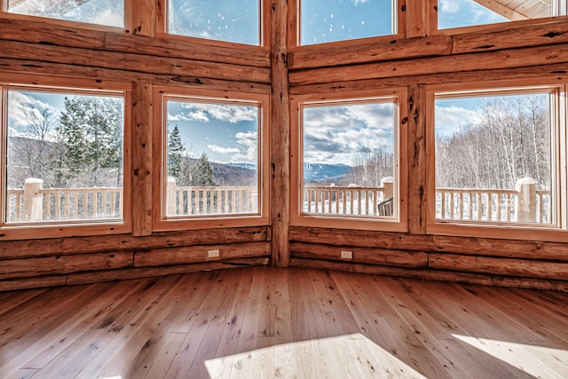 unfurnished sunroom with a mountain view