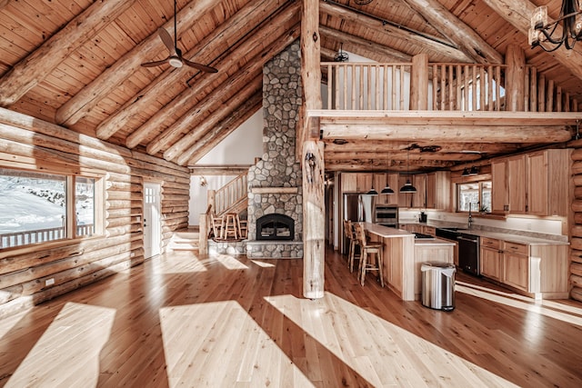 unfurnished living room featuring wood ceiling, log walls, beam ceiling, high vaulted ceiling, and light hardwood / wood-style floors