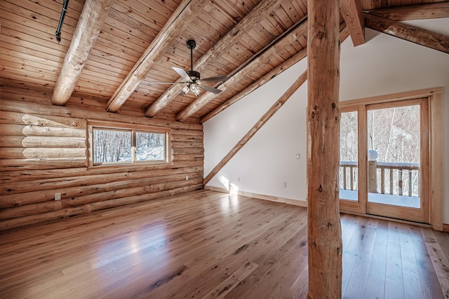 interior space featuring rustic walls, a wealth of natural light, and hardwood / wood-style floors