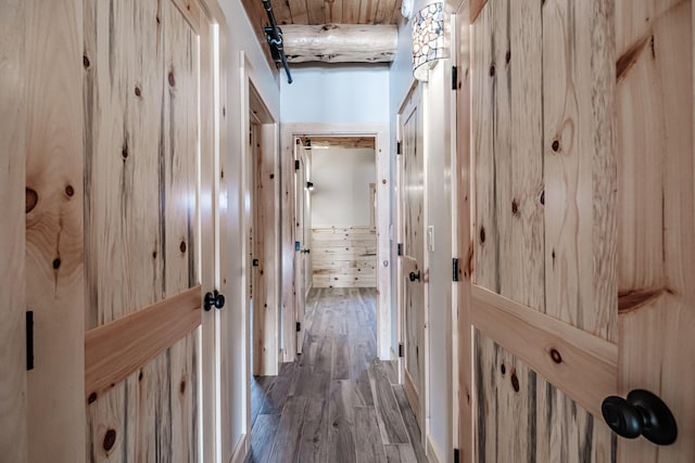 hallway with wood-type flooring and wooden walls