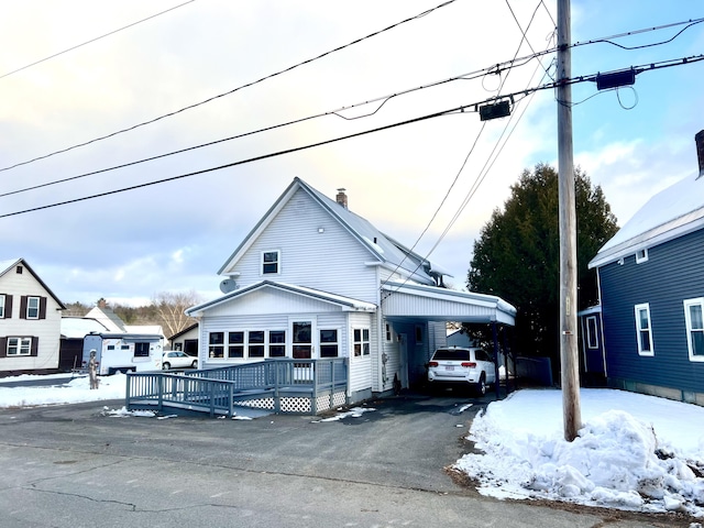 view of front facade featuring a deck and a carport