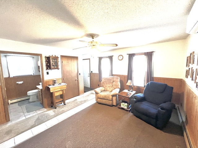 tiled living room featuring a textured ceiling, an AC wall unit, baseboard heating, and wooden walls