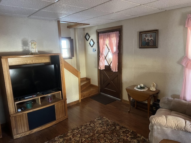 interior space with dark hardwood / wood-style floors and a drop ceiling