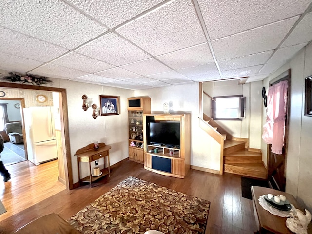 living room featuring a drop ceiling and wood-type flooring