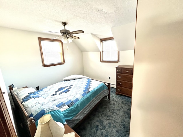 carpeted bedroom featuring baseboard heating, ceiling fan, a textured ceiling, and vaulted ceiling