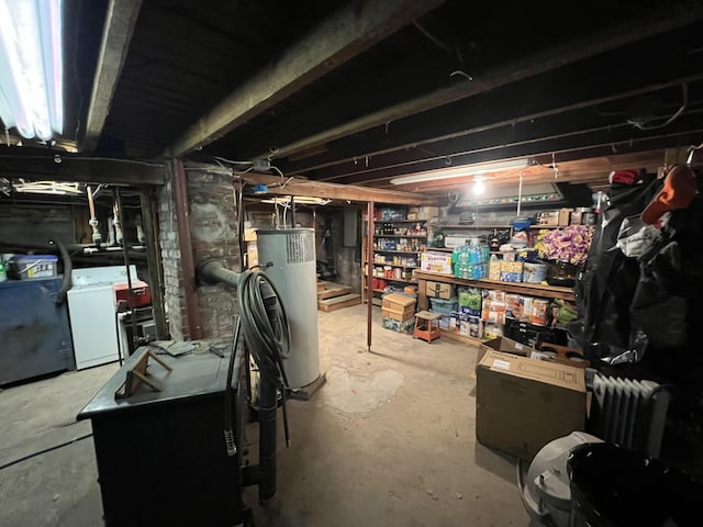 basement featuring water heater and washer / dryer