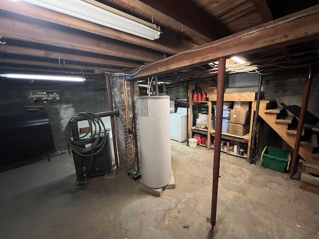 basement featuring gas water heater and washer / clothes dryer