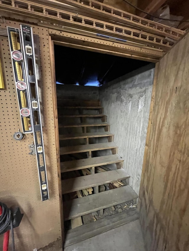 stairway featuring concrete floors