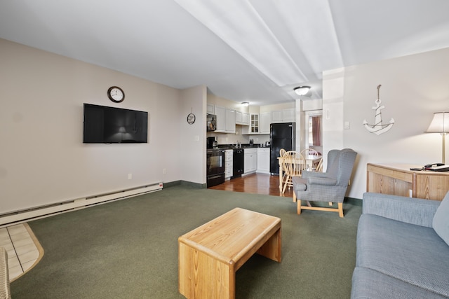 carpeted living room featuring a baseboard heating unit