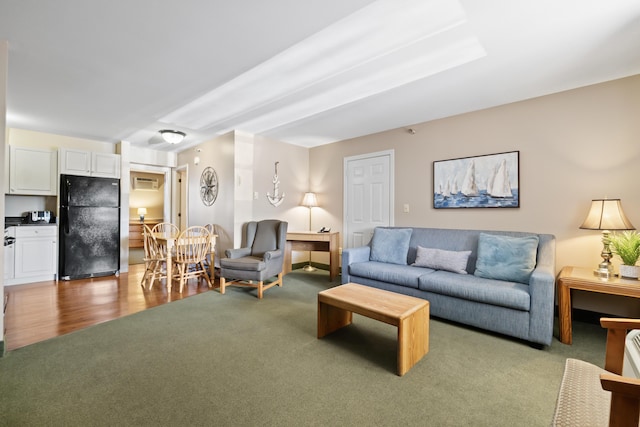 living room featuring a wall mounted AC and carpet